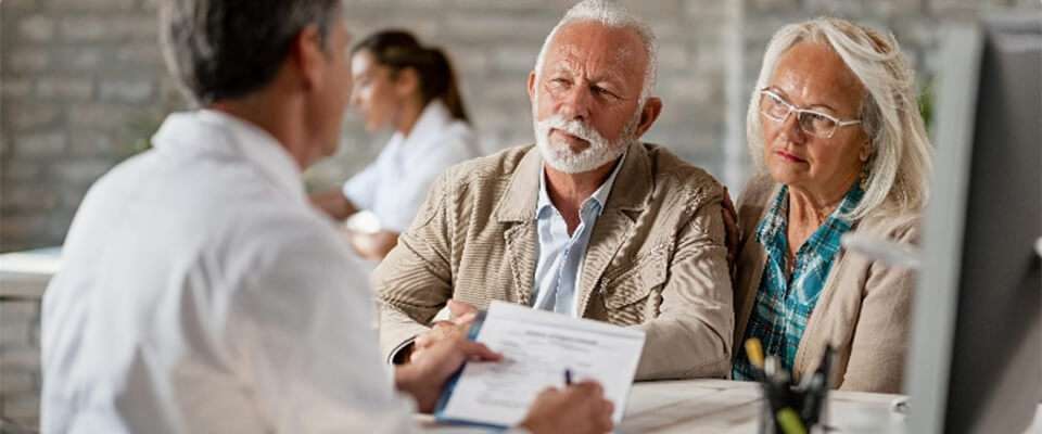 husband and wife talking to a doctor