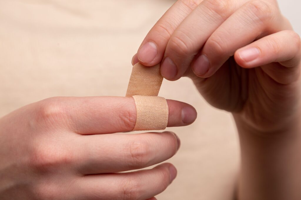 applying a bandaid to index finger