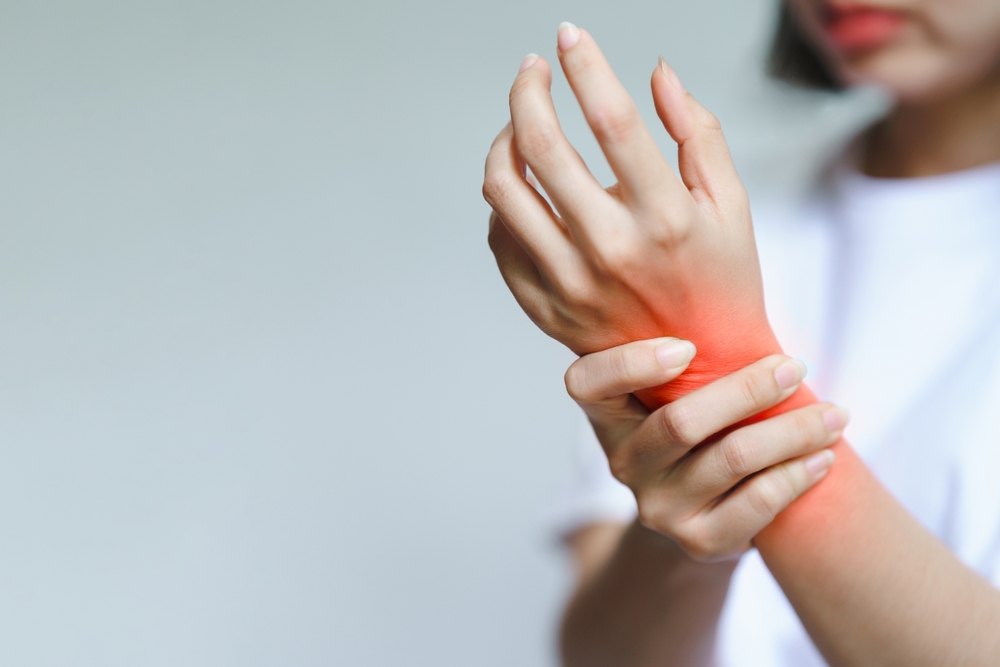 woman rubbing her wrist in pain